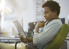 Pictured: Customer browses online reviews on a tablet computer.